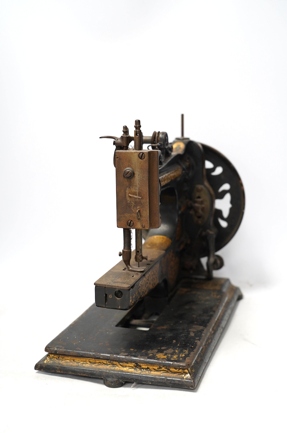 An 1870's Edward Ward sewing machine and a cast iron base with gilt decoration and maker’s marks. Condition - fair